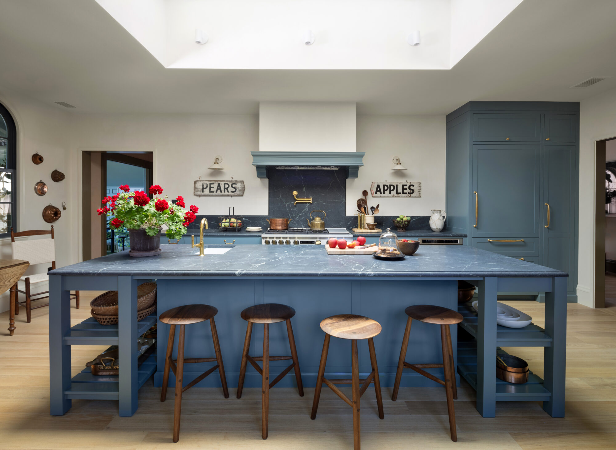 Blue cabinets and soapstone countertops are in this kitchen