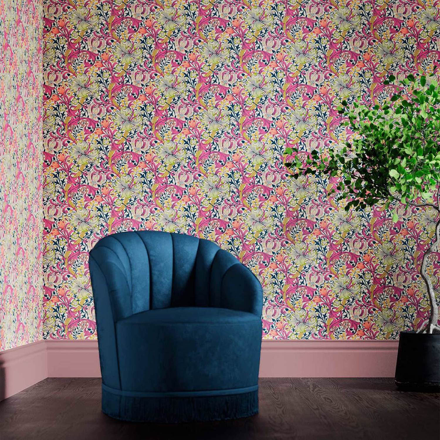 colorful floral wallpaper behind a blue velvet armchair