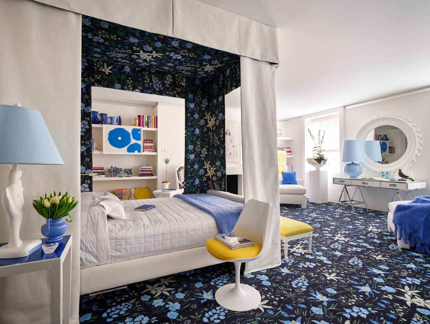 bedroom with blue floral carpet and matching canopy bed at Kips Bay Decorator Show House New York