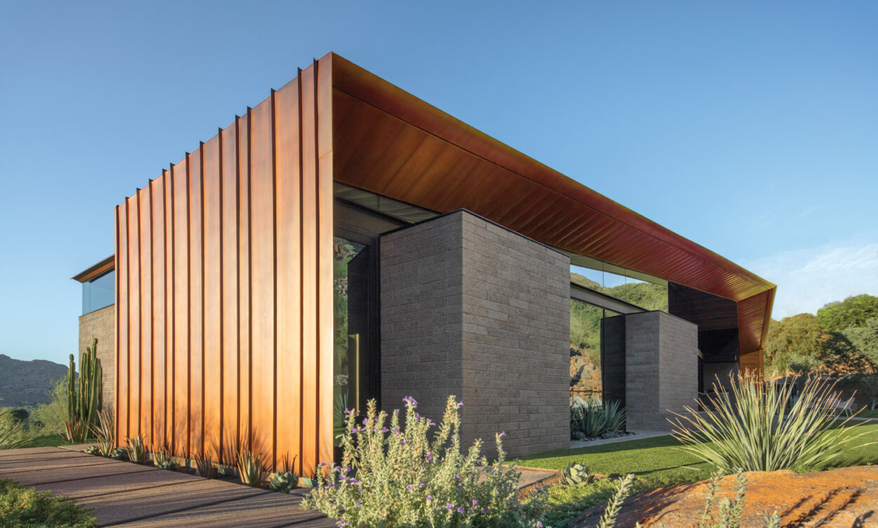 Exterior contemporary desert home with a copper overhanging roof and concrete-block walls