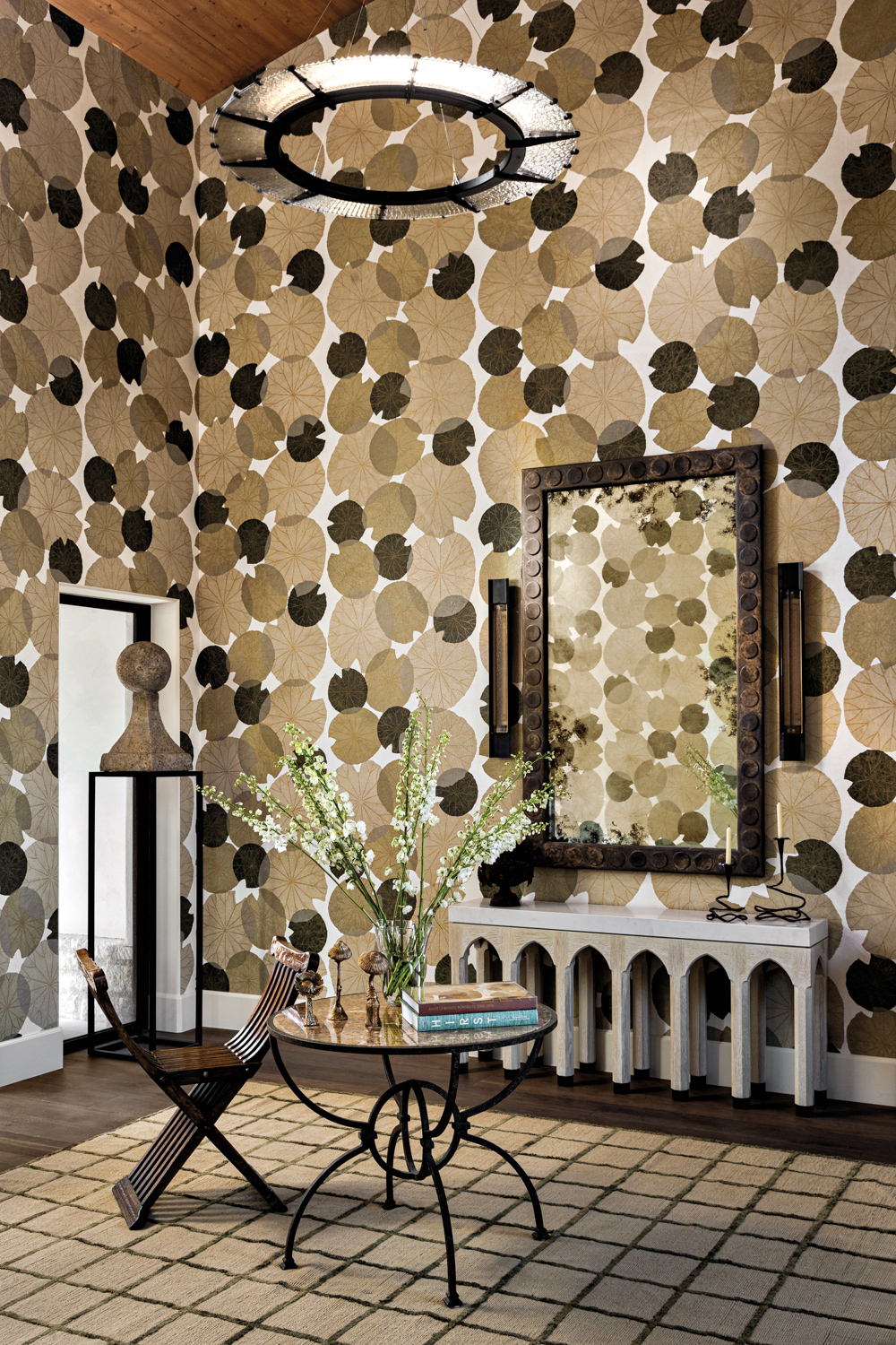 foyer with patterned wallpaper, round...