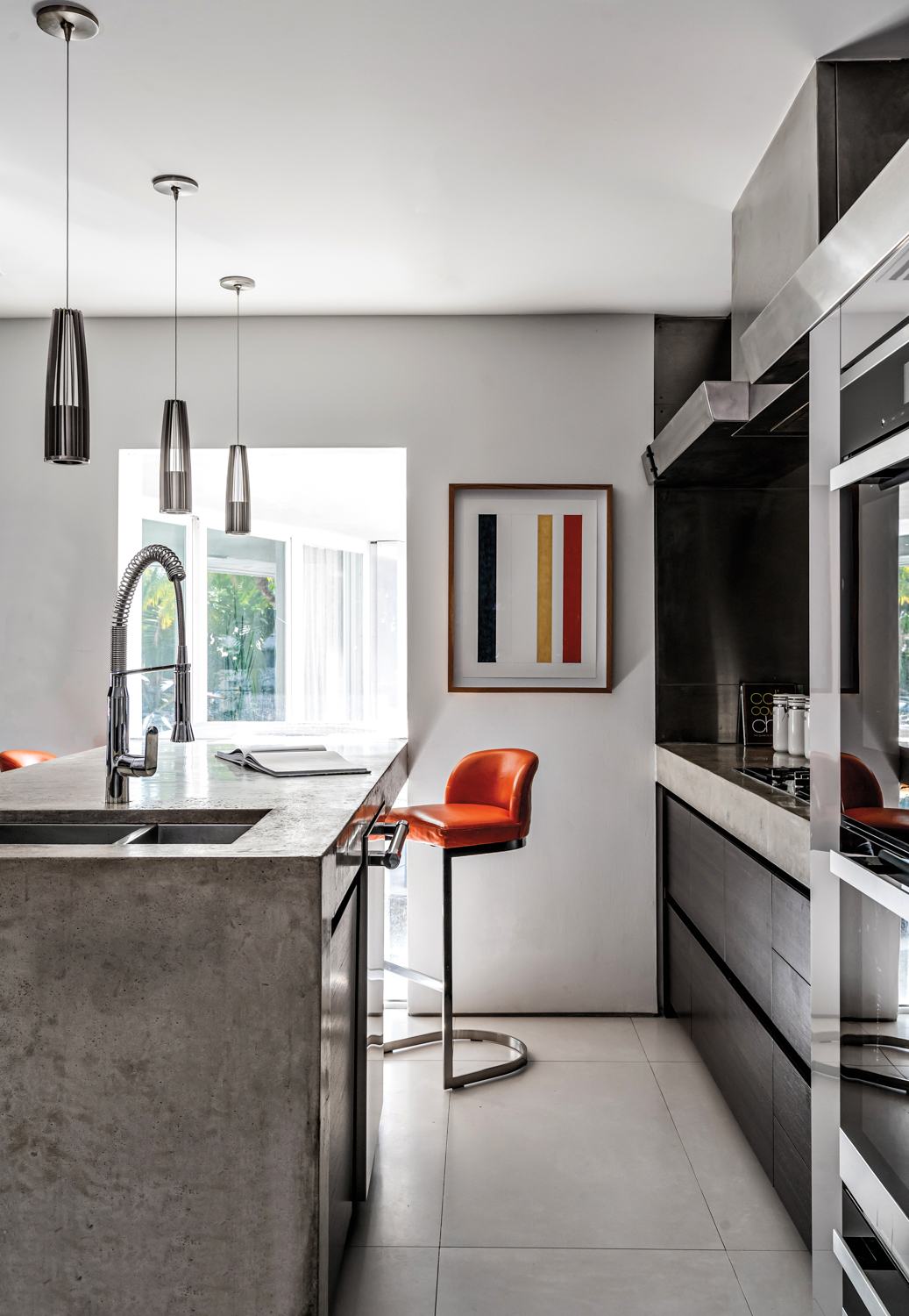 kitchen with concrete island, orange...