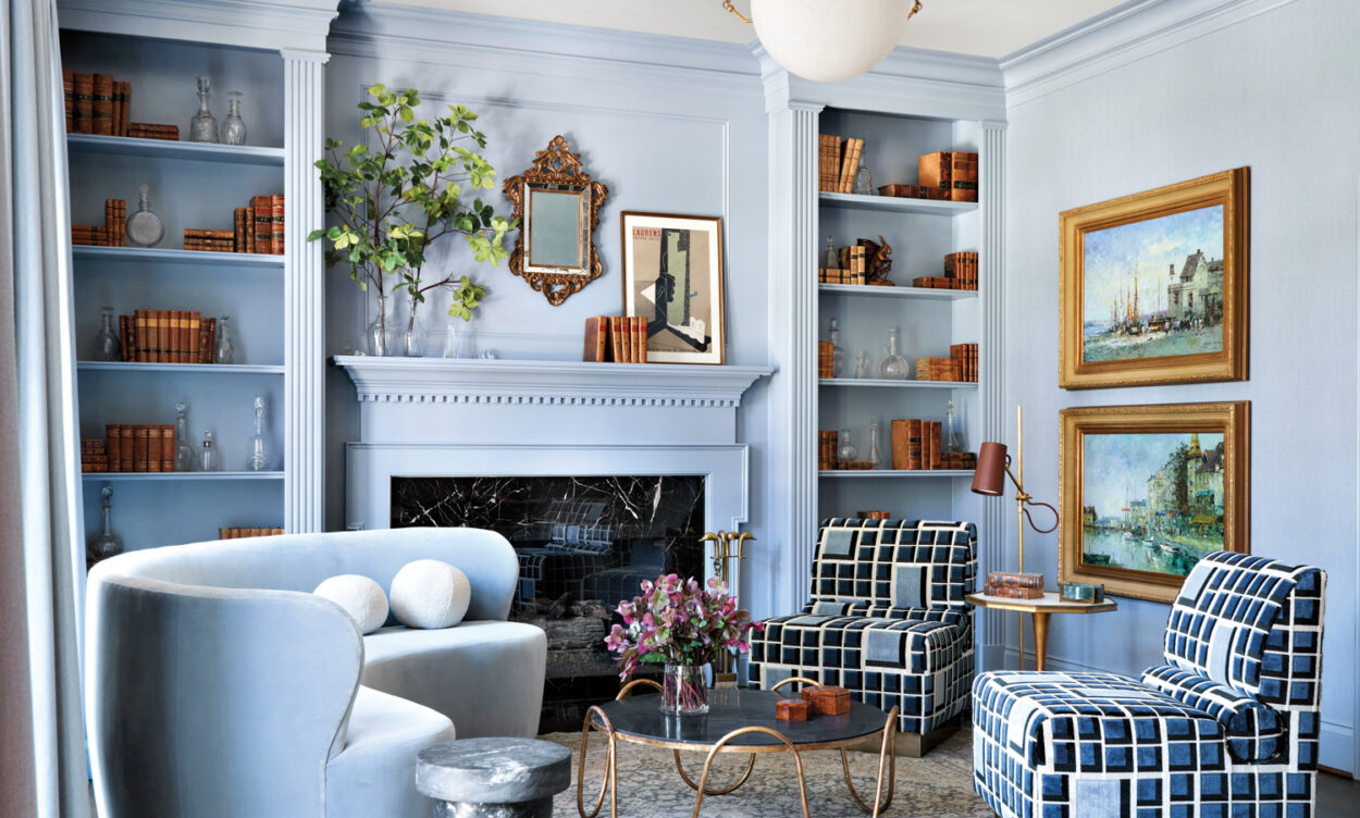 powder blue living room with geometric patterned chairs and curved sofa