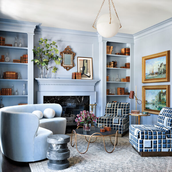 powder blue living room with geometric patterned chairs and curved sofa