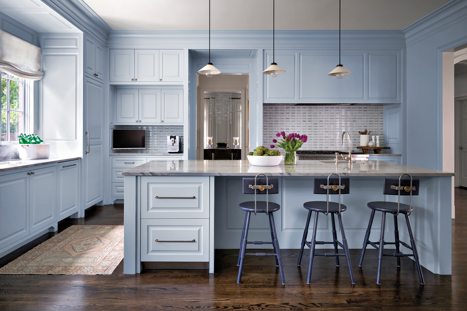 light blue kitchen with paneled...