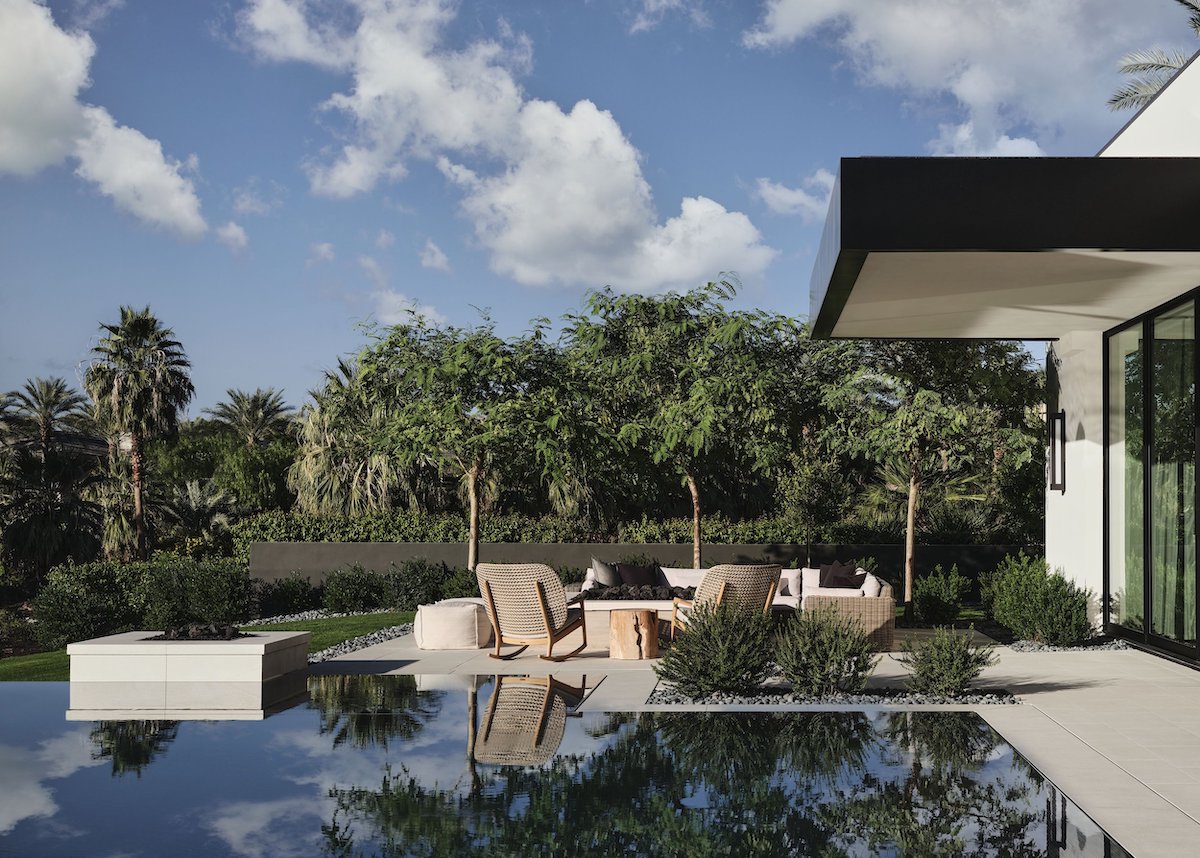 A contemporary house with a pool and outdoor seating area, perfect for relaxation and entertainment.