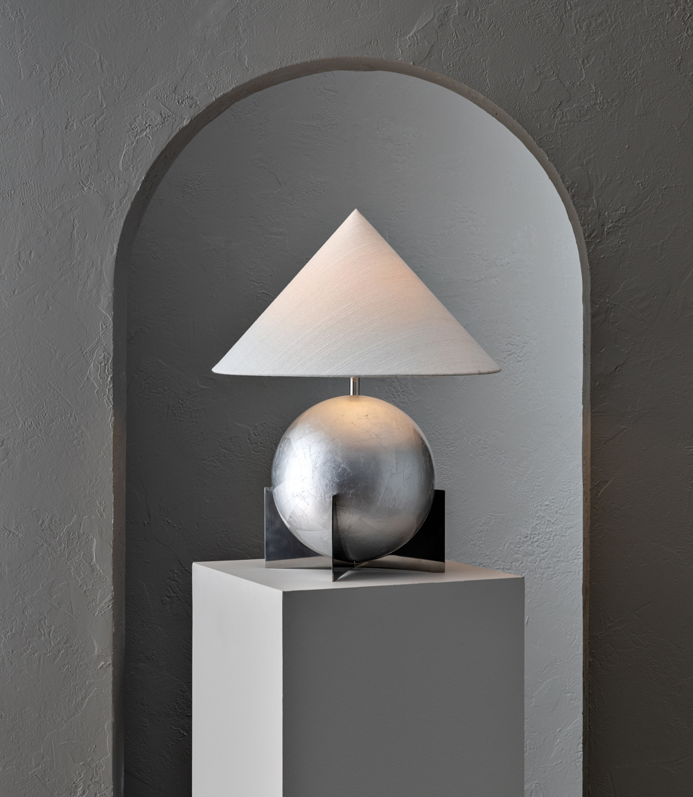 table lamp with silver spherical base and a triangular shade