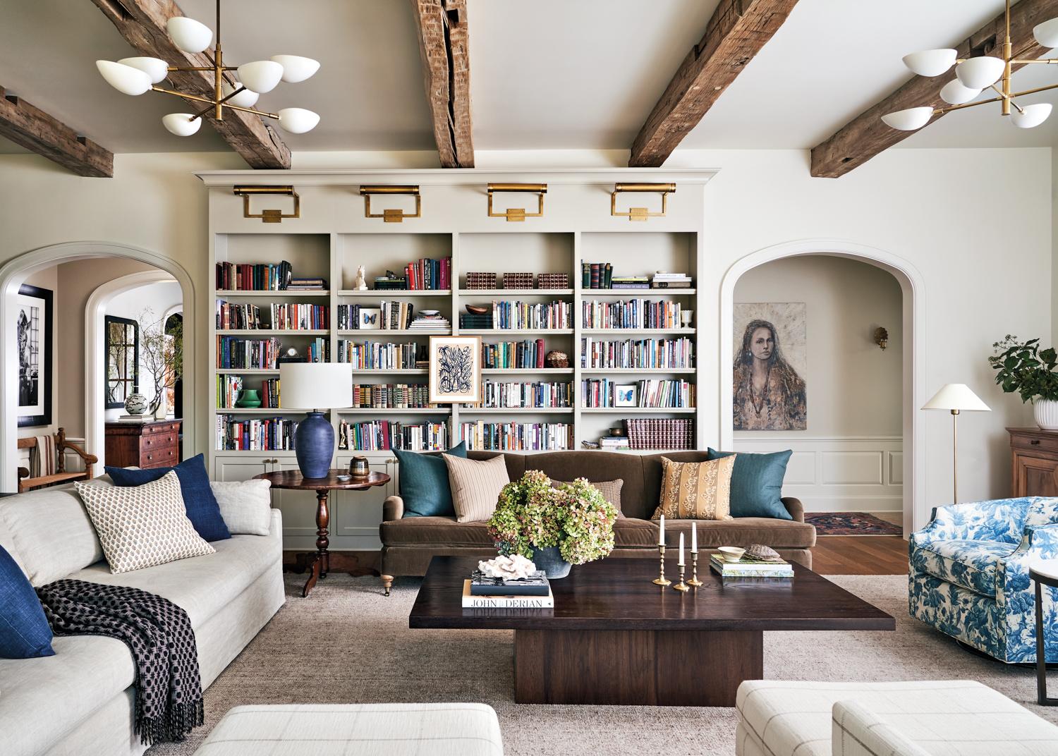 living room with exposed beams and built in bookcases