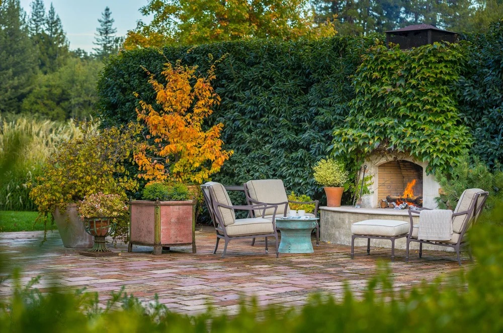 A cozy patio features cushioned chairs around a table