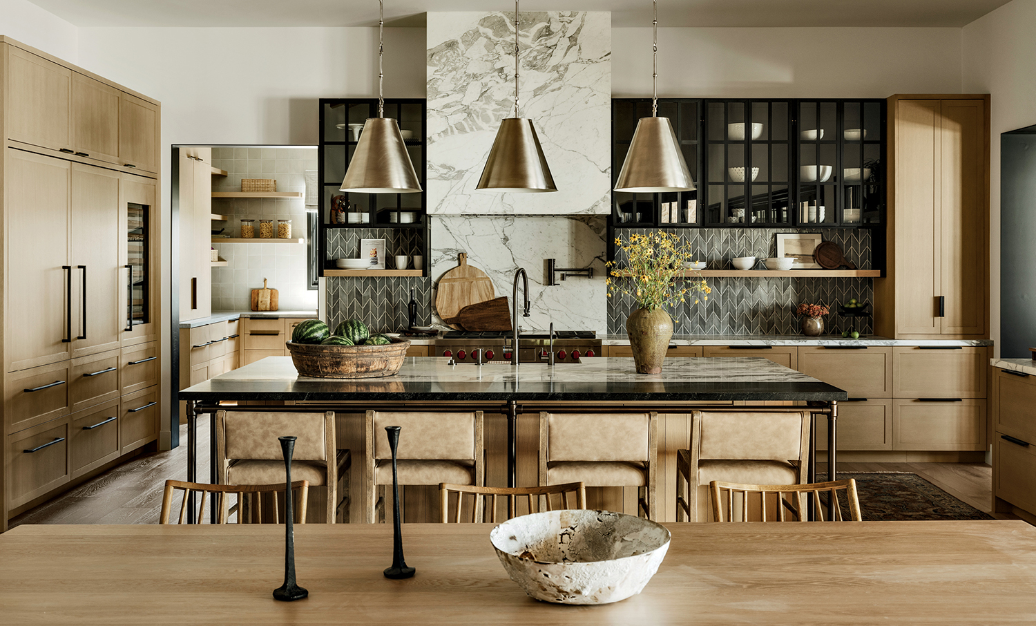 modern farmhouse kitchen with light woods, mixed metal finishes and marble counters