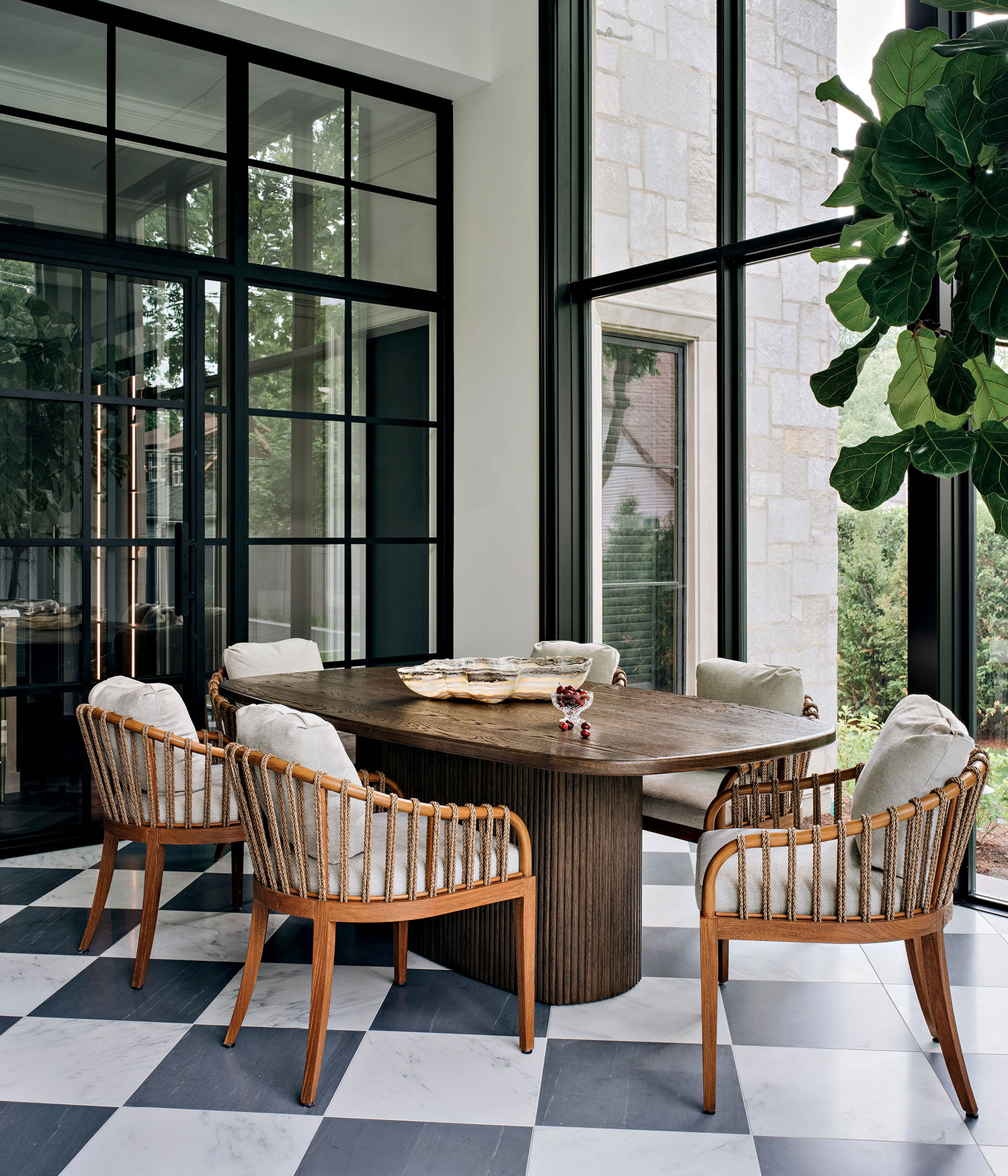 dining area in a sun room with checkerboard marble floors