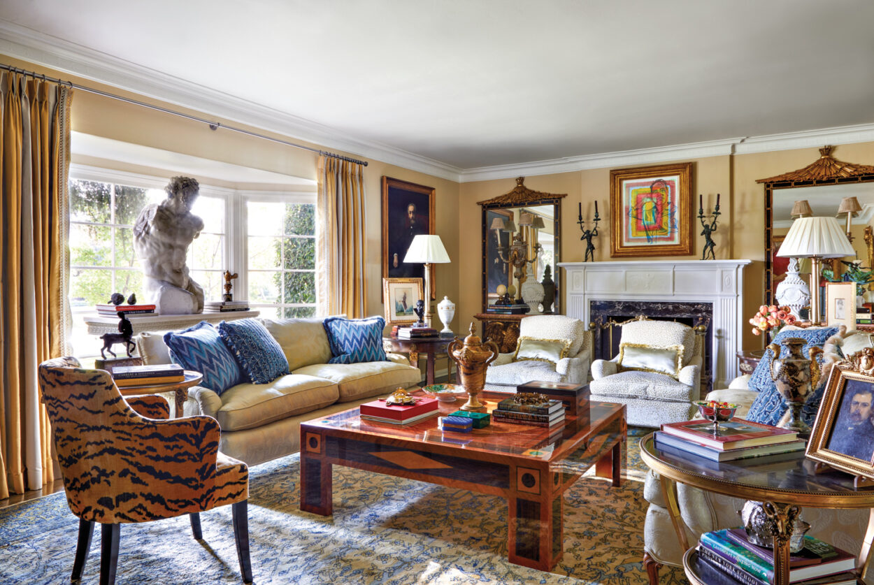 living room seating area with fireplace and custom and antique furnishings
