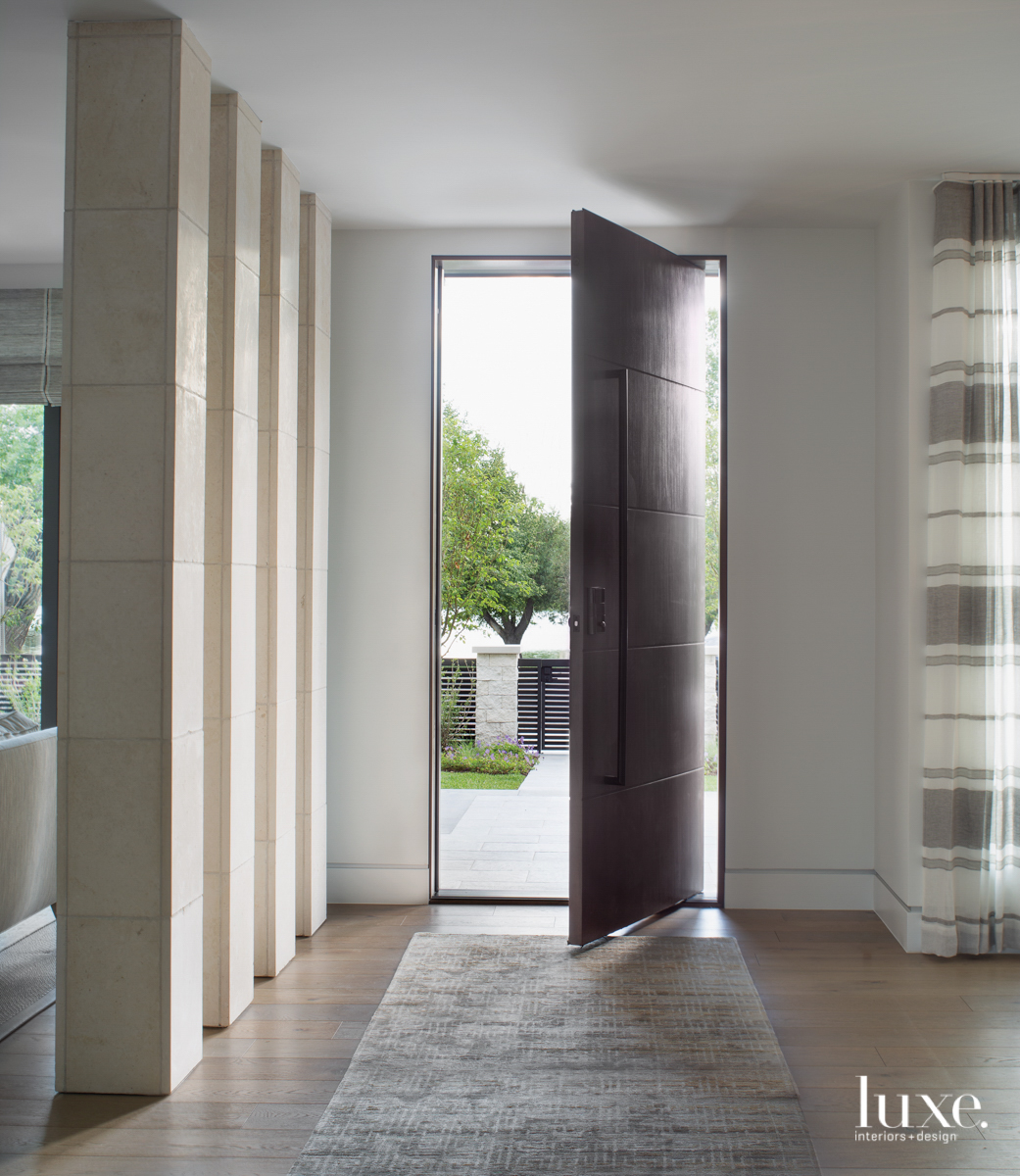 limestone columns entryway with walnut front door