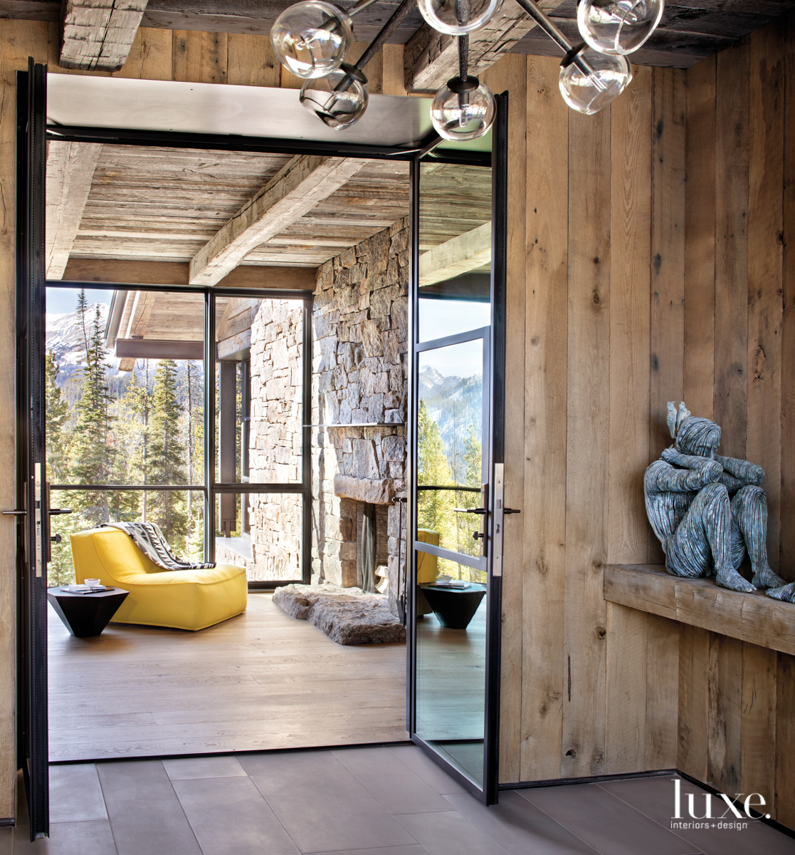 Entry with view into a sitting room furnished with a yellow chair.