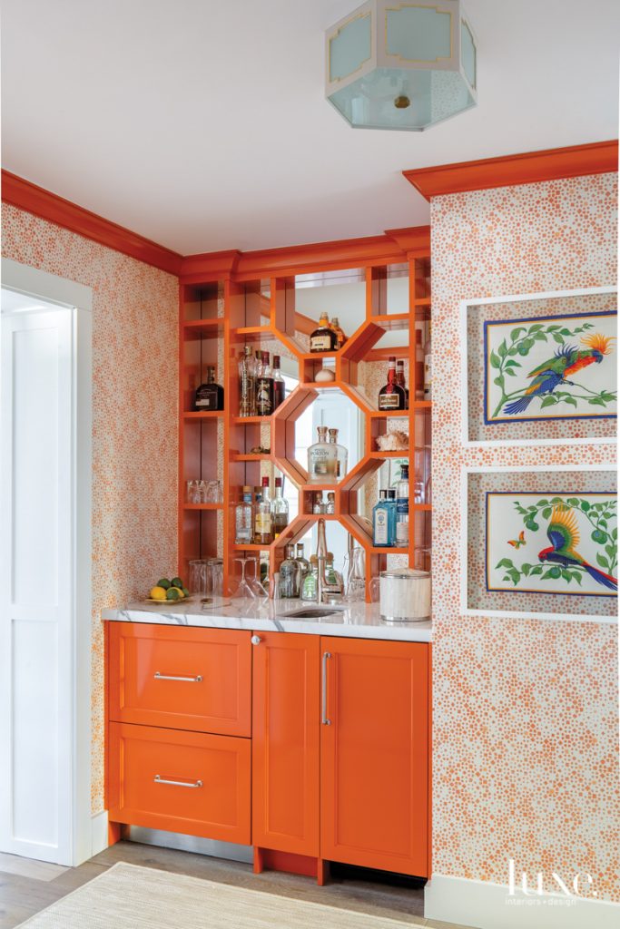 orange bar with framed vintage hermes scarves