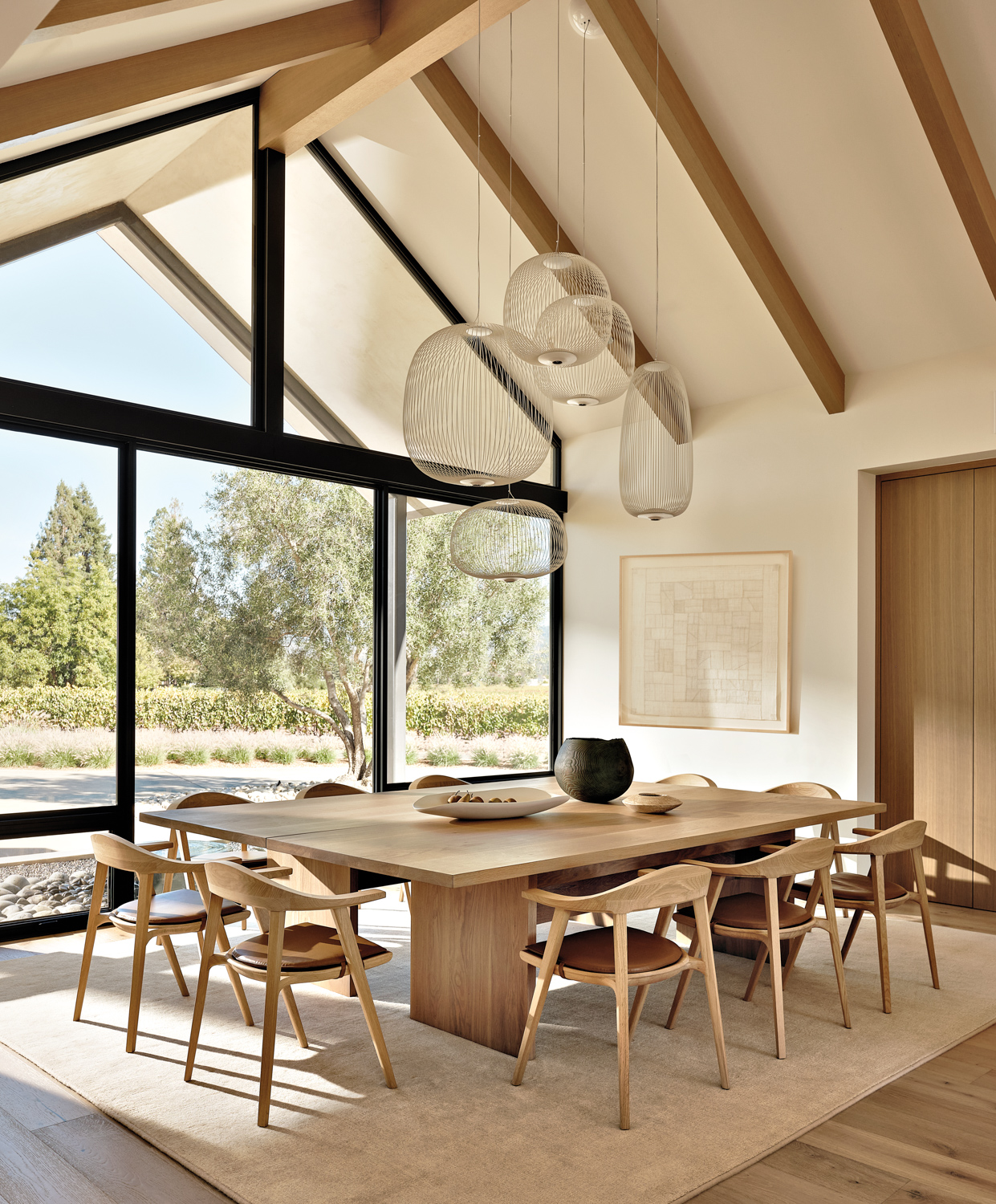 bright dining area with white walls and light wood furnishings