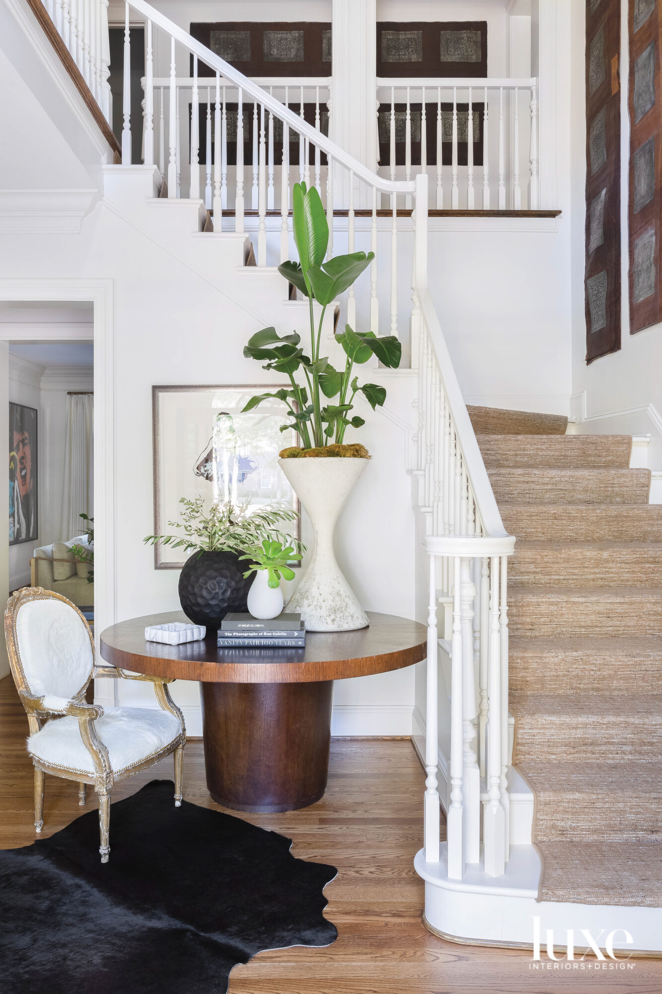 Round table, antique chair and stairwell