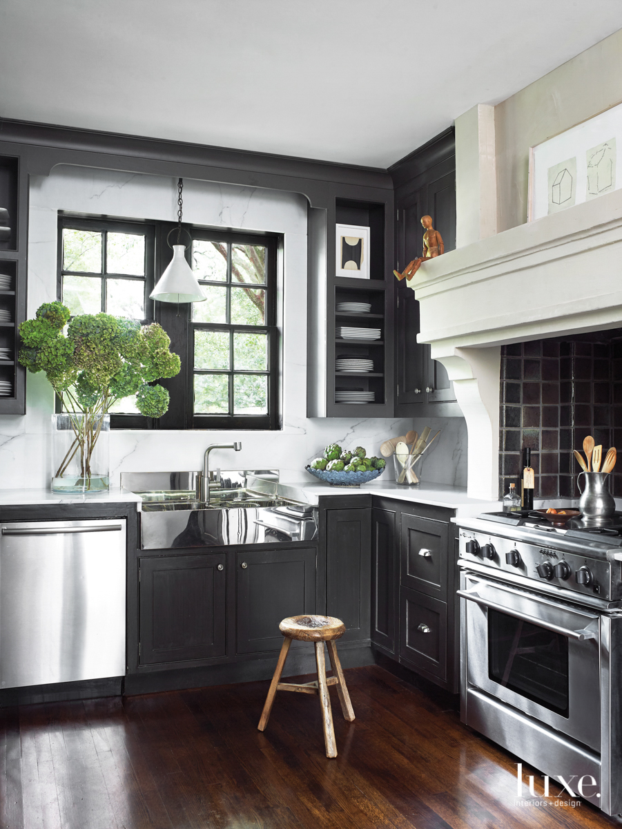 Houston kitchen with dark cabinetry and Calacatta gold marble countertops