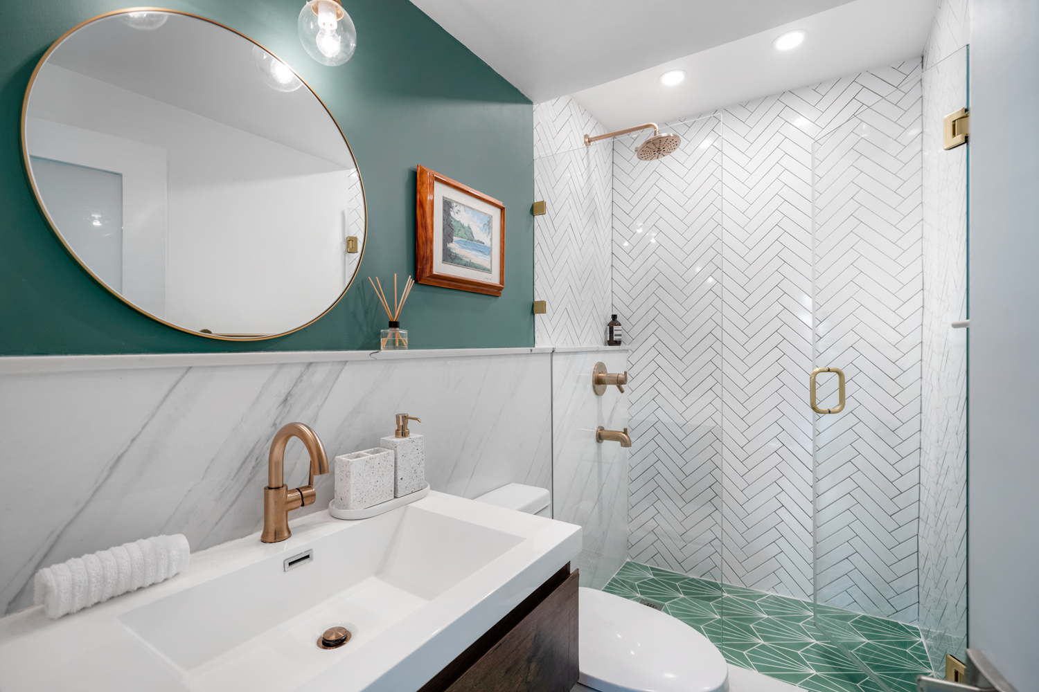 dark blue bathroom with white sink and round mirror
