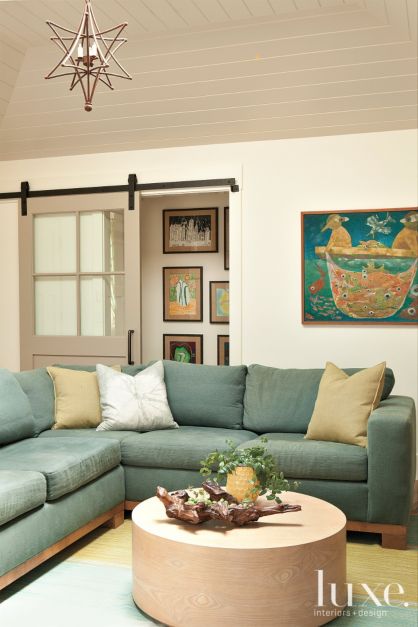 barn door separates lounge area white green sectional
