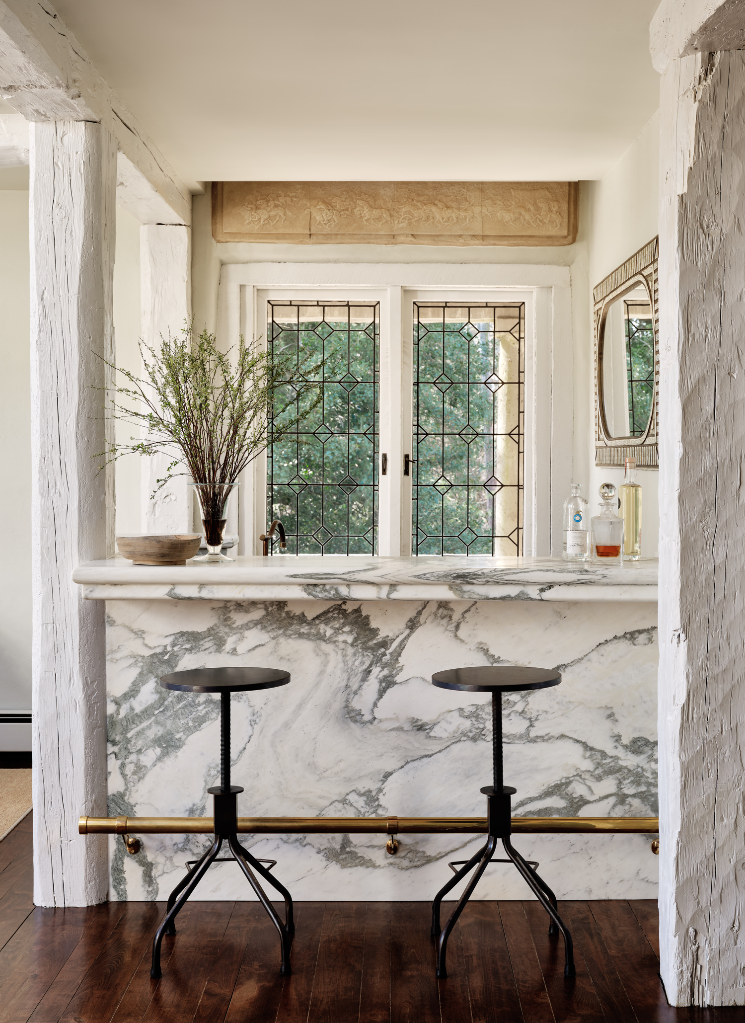 white marble kitchen with brown bar stools