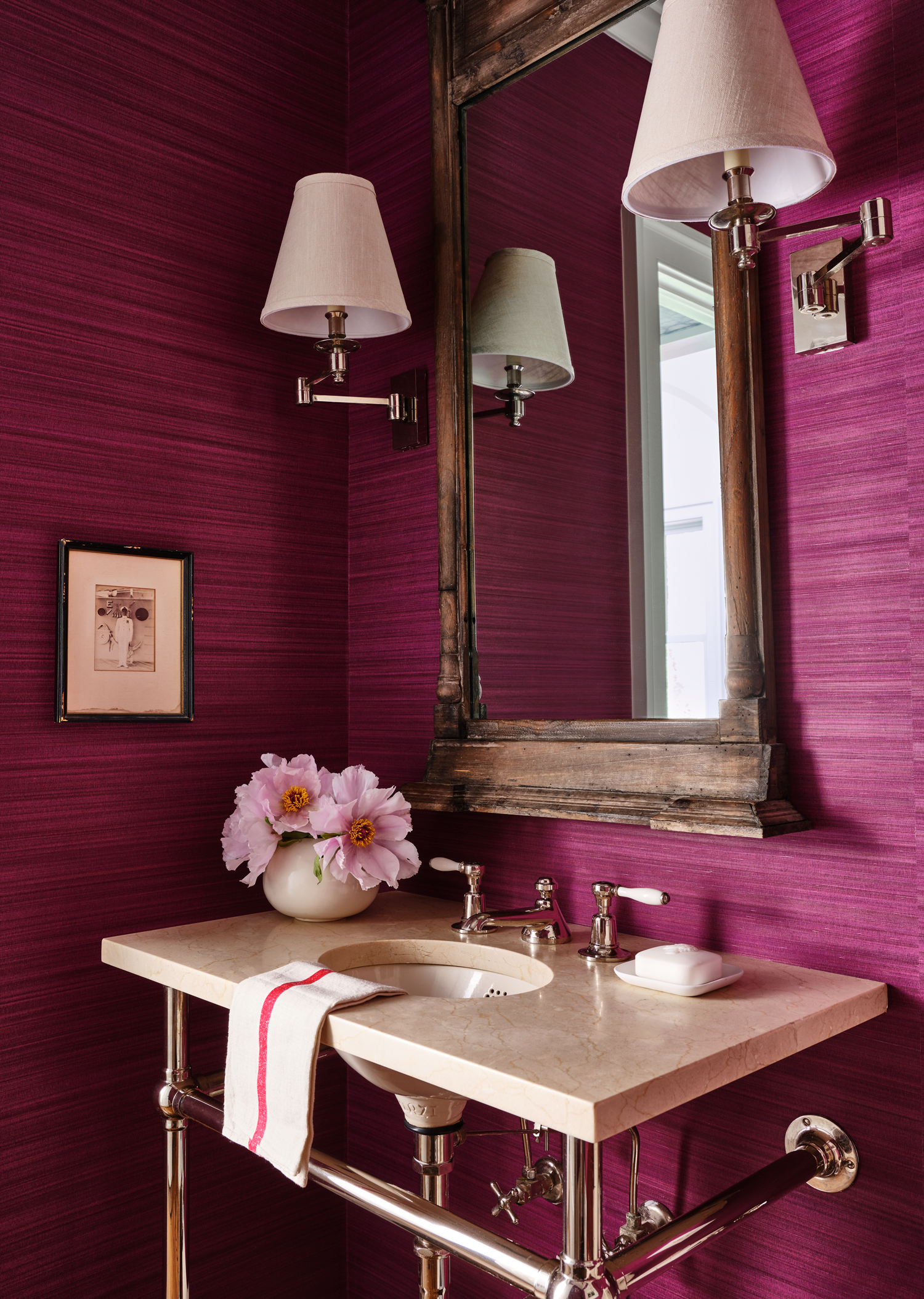 fuschia powder room with wooden mirror and white sink