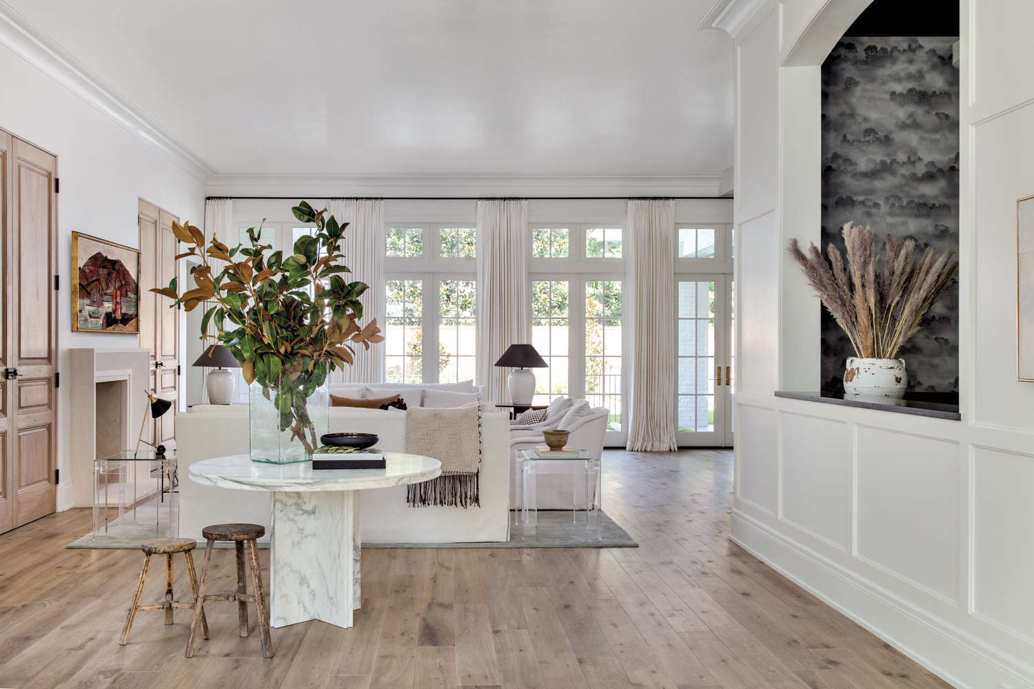 entry featuring a marble table overlooking a light-filled living room