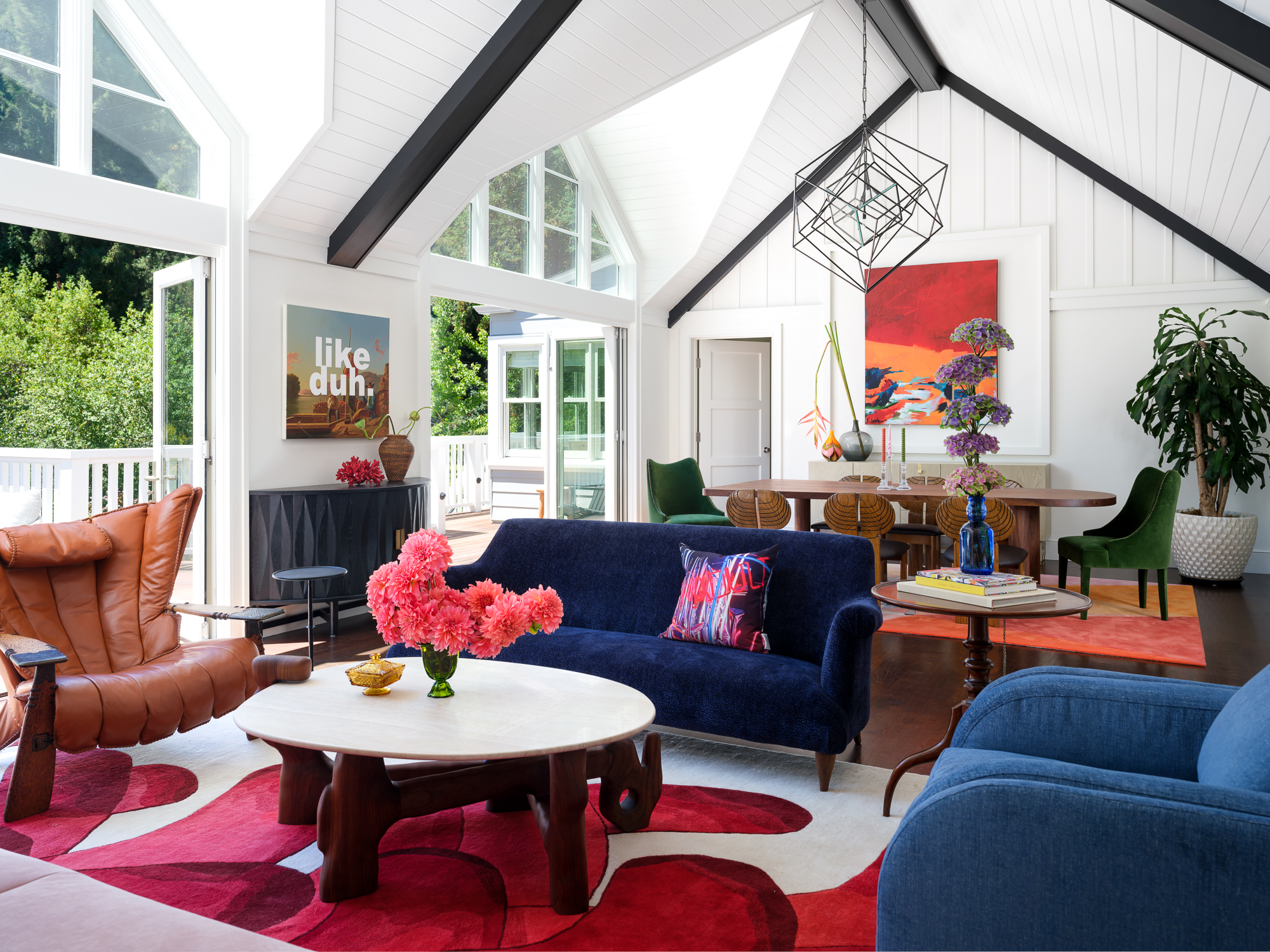 living room with bright red flooring and blue couches