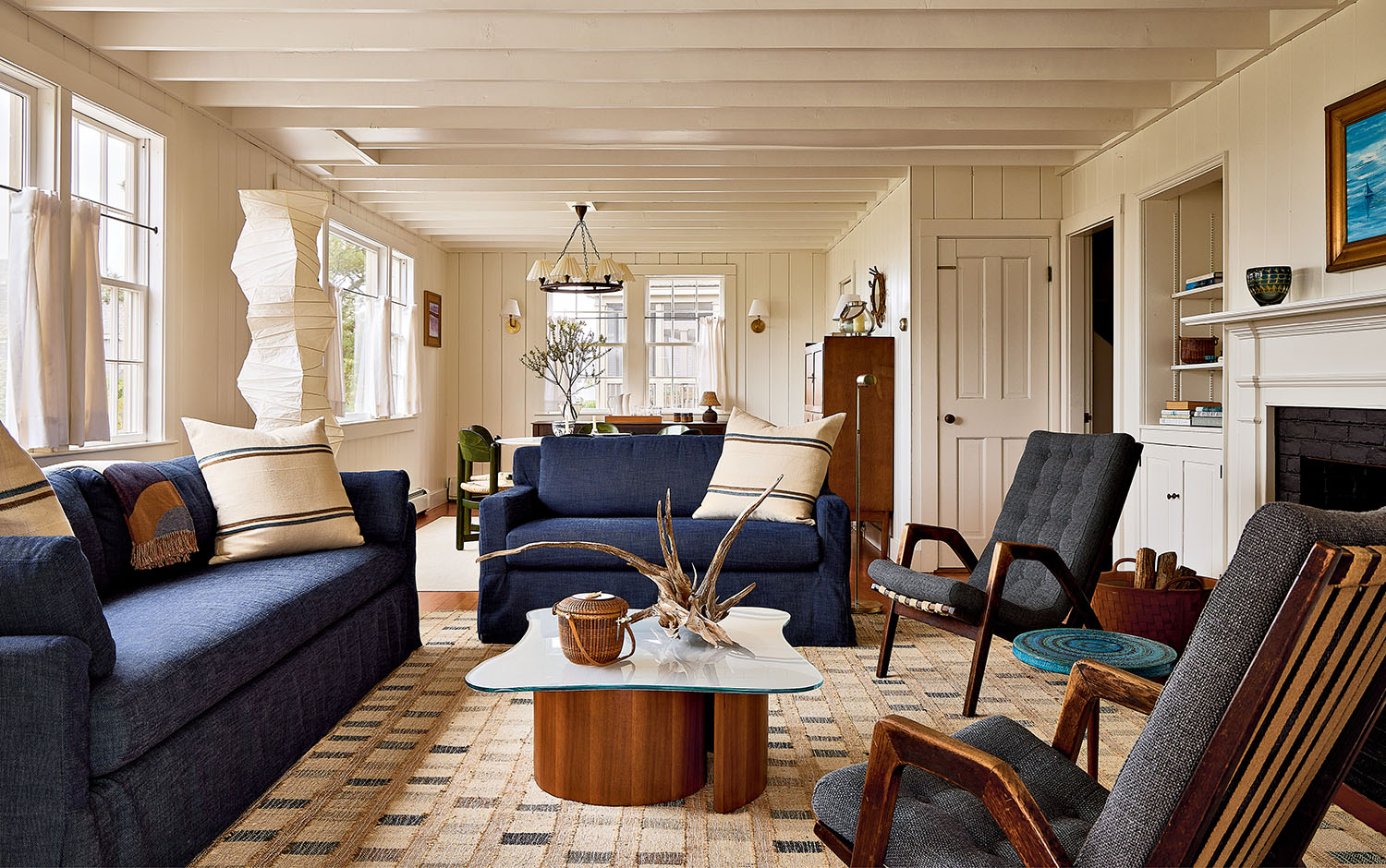 A cozy living room featuring a blue couch and matching chairs, creating a welcoming atmosphere.