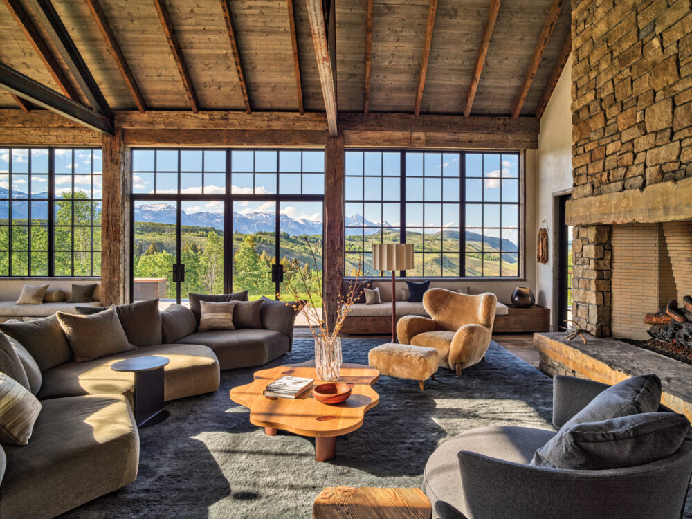 A modern living room showcasing a rustic stone wall and a soft couch, perfect for leisure and socializing.