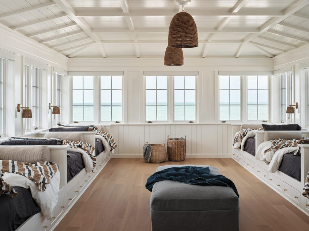 A bright bedroom featuring white walls and warm wooden floors, creating a cozy and inviting atmosphere.