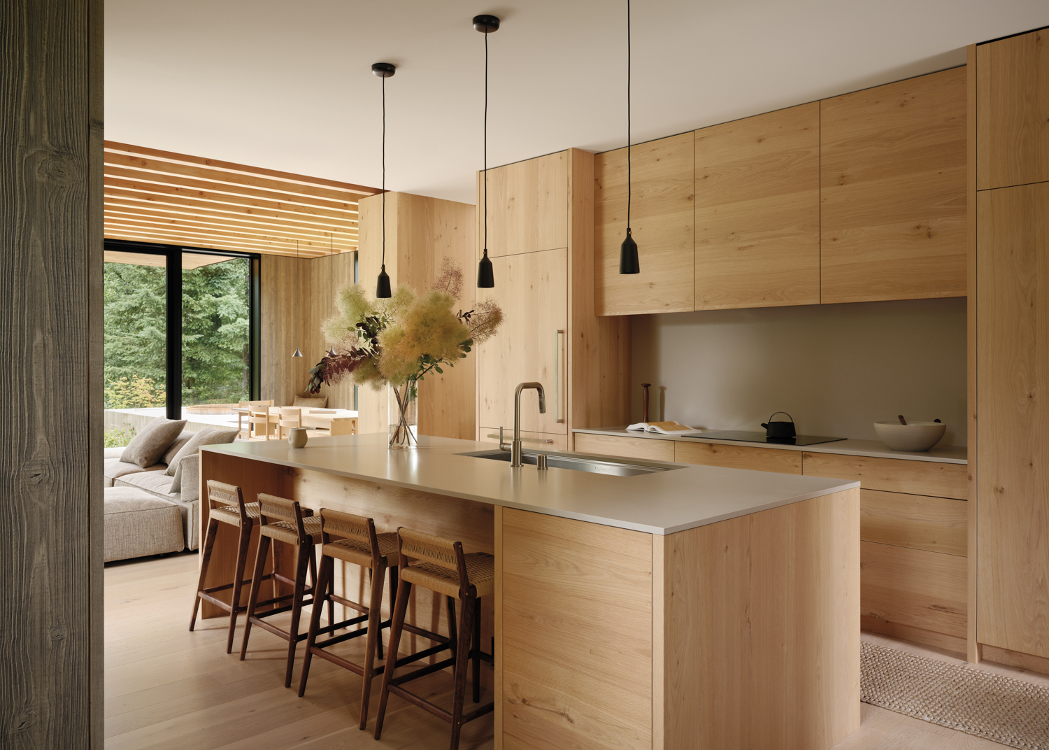 A modern kitchen featuring wooden cabinets and a spacious central island for cooking and dining.